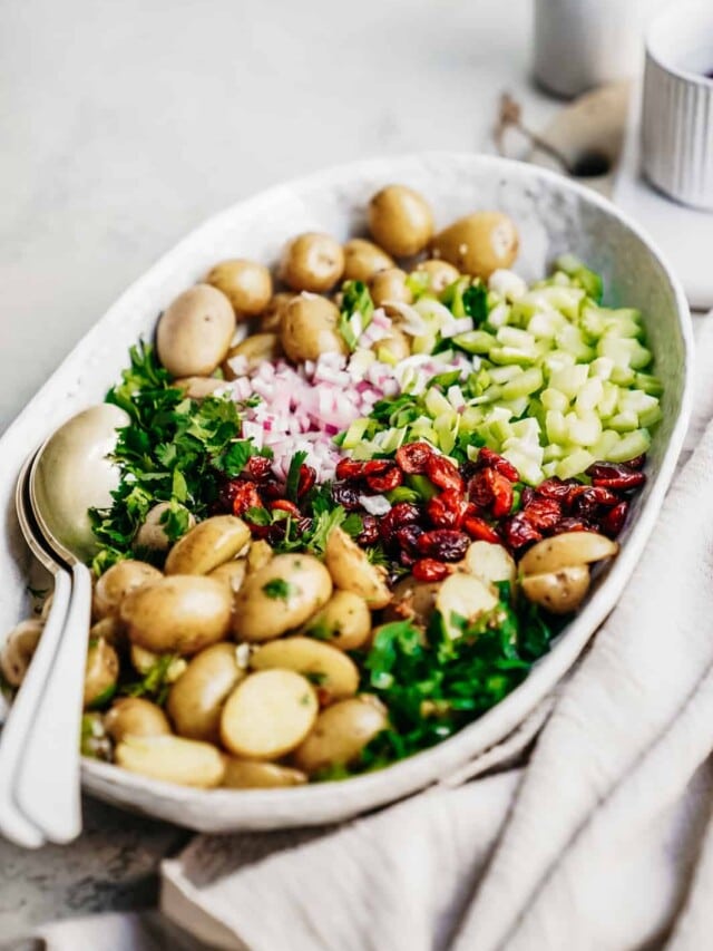 Big serving dish with beautiful and colourful Vegan Potato Salad Recipe ready to be served.