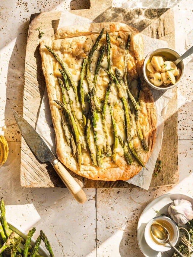 Asparagus and Cheese Tart on cutting board with sun shining through window.