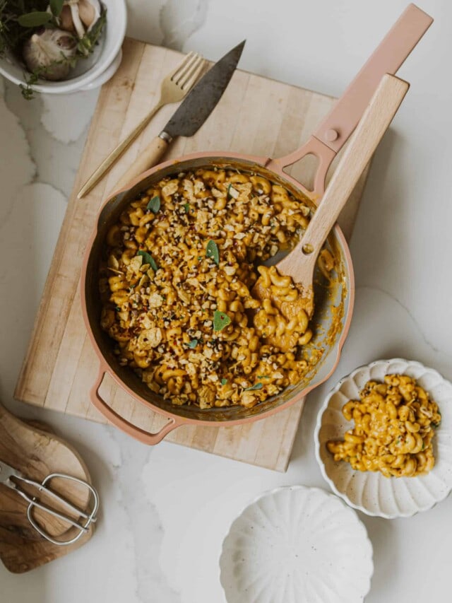 Vegan Pumpkin Mac and Cheese on cutting board in pot with spoon