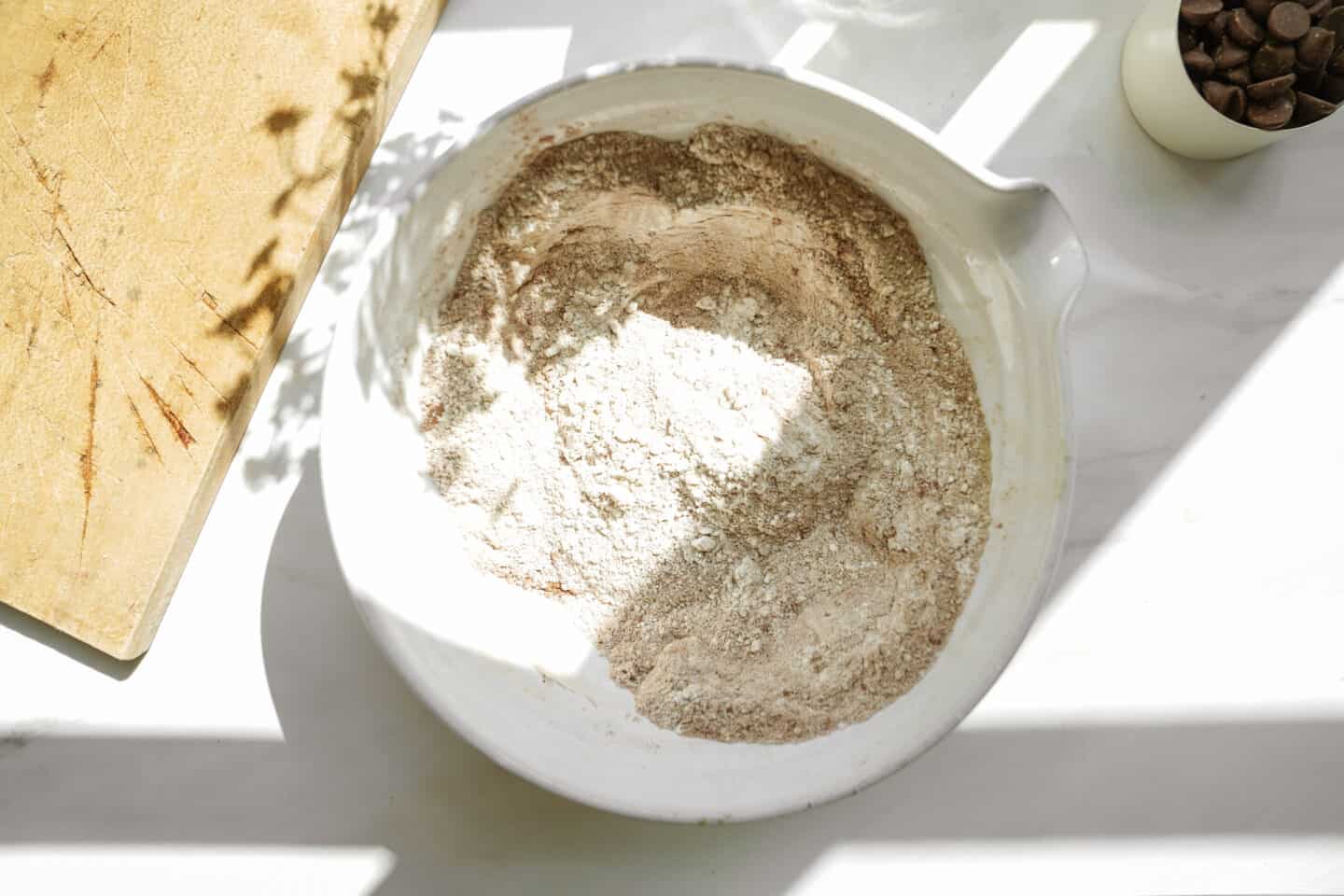 Dry ingredients in a white bowl for protein cookies