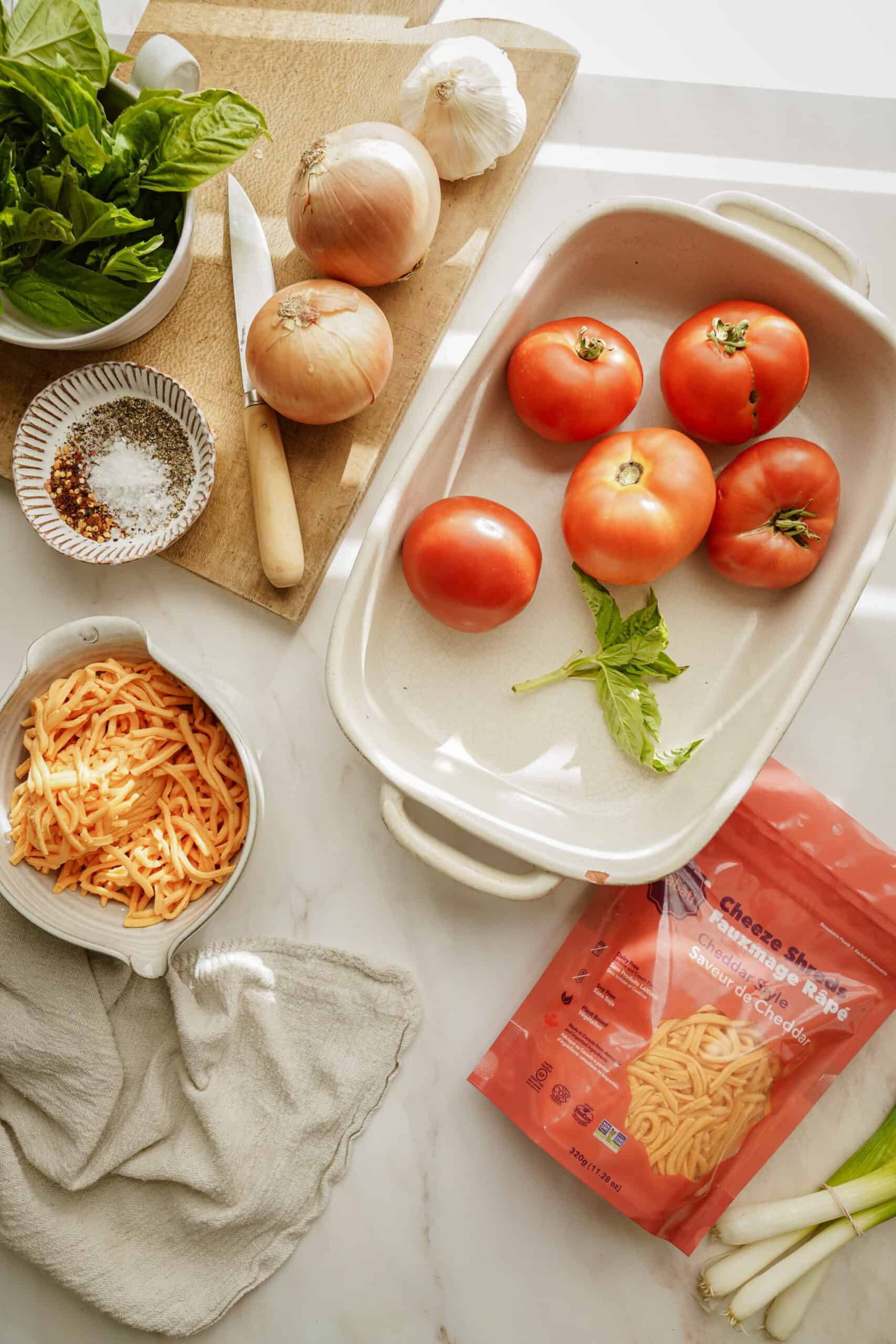 Ingredients for creamy tomato soup in a casserole dish