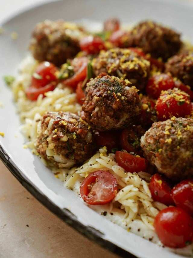 Vegan greek meatballs close-up with creamy orzo