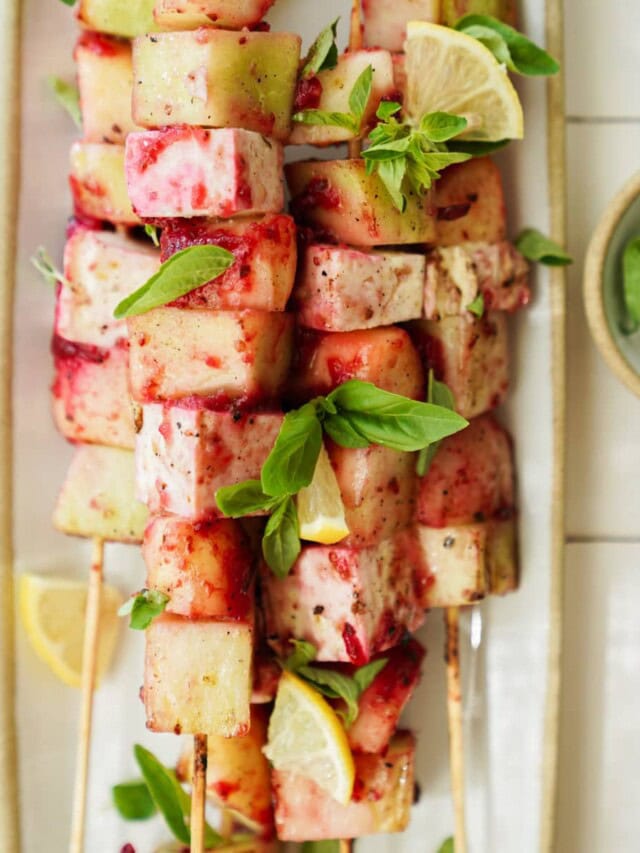 Fruit kabobs on the grill on a serving dish