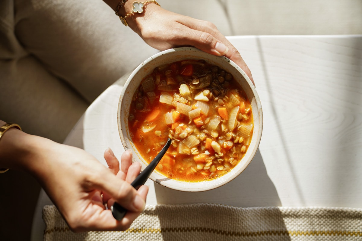 Spoon in a bowl of lentil soup