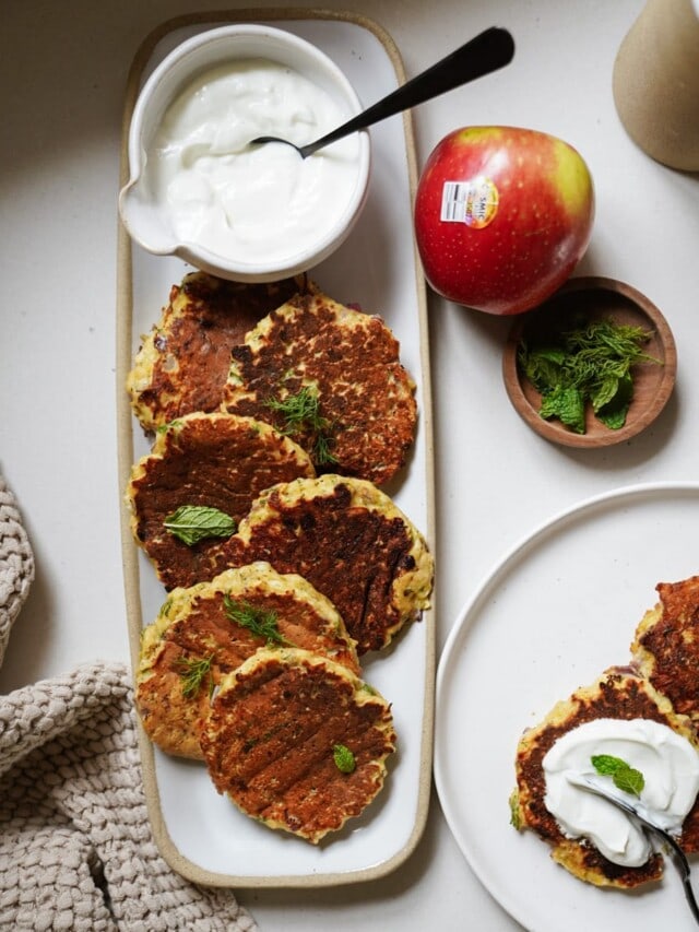 Pumpkin fritters on a serving dish with ingredients