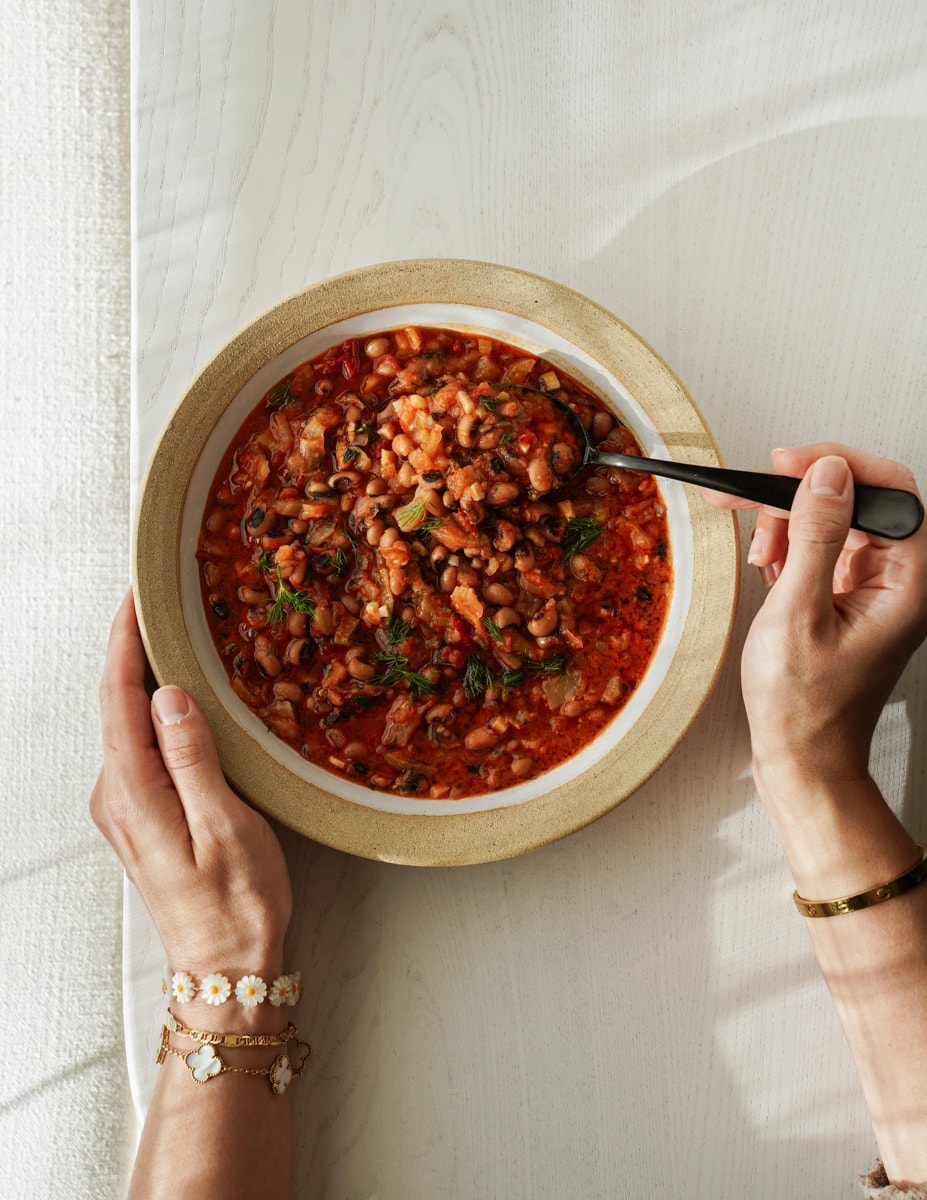 Black eyed pea soup in a bowl with a spoon