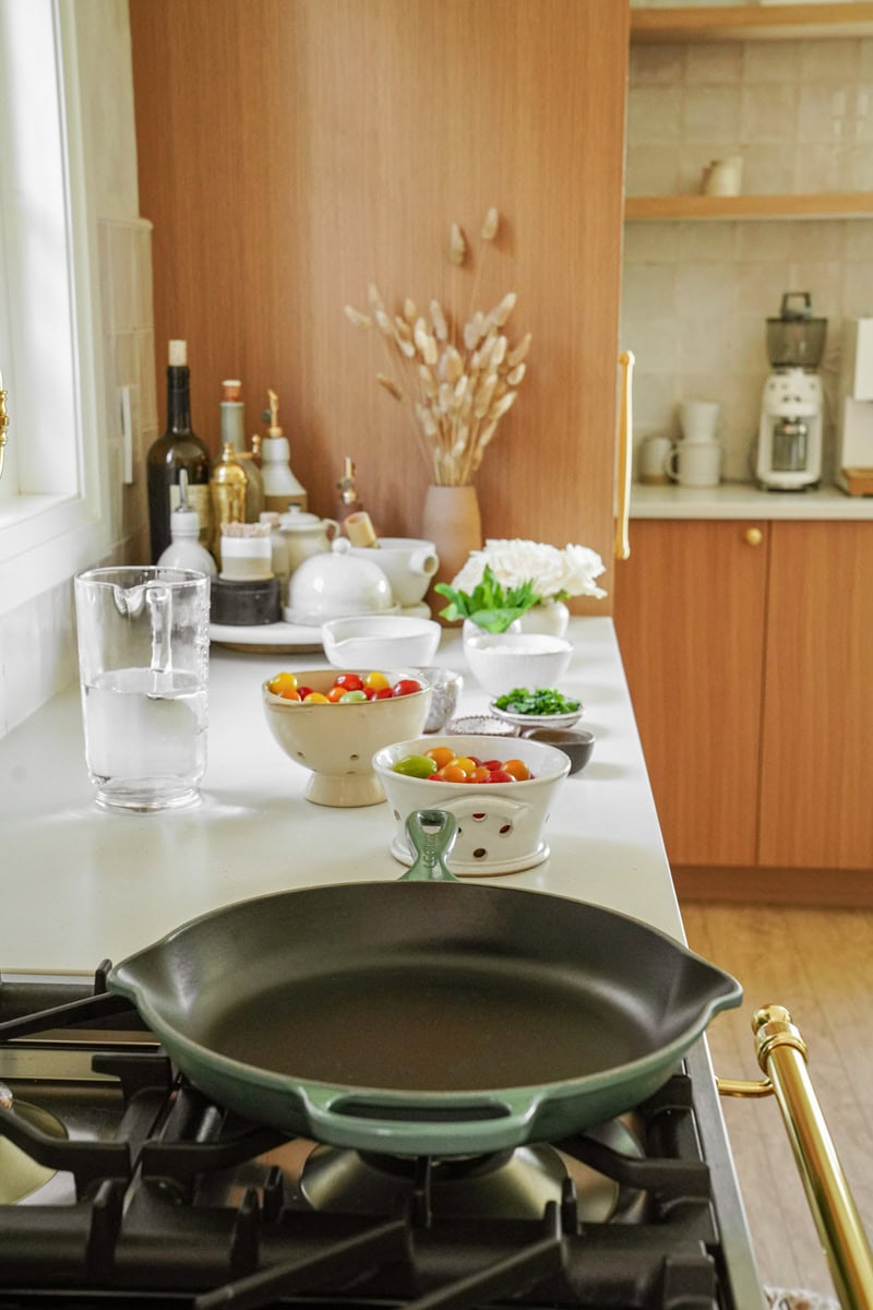 Pan with ingredients beside it on a counter