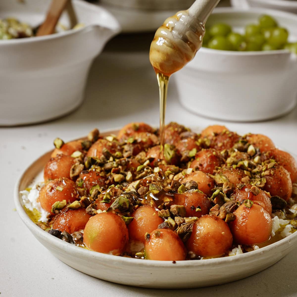 Honey being poured on Cantaloupe Salad