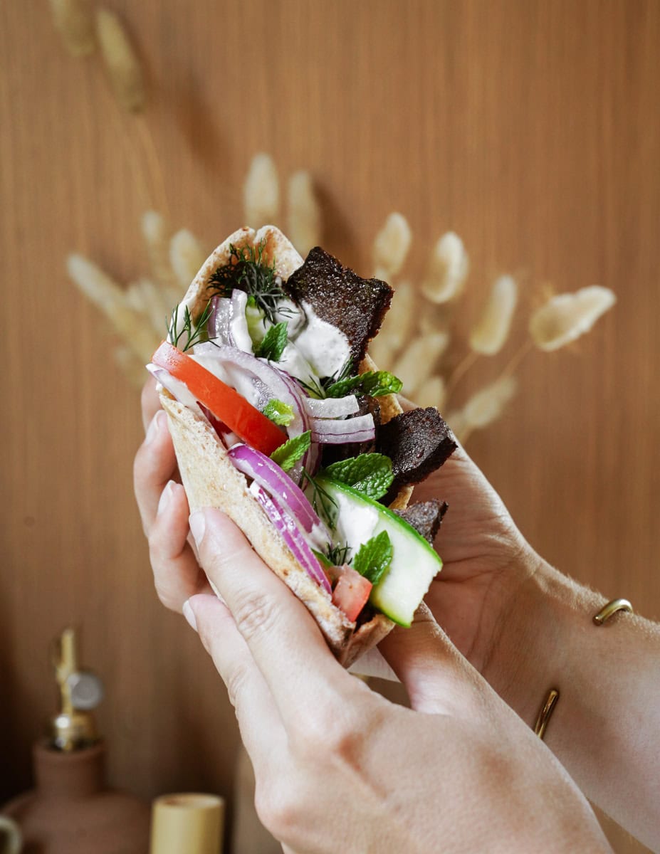 Hand holding Greek Gyro