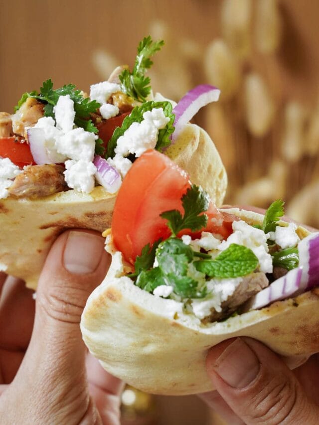 Marinated Chicken Thighs in Mini Pitas being held by hands