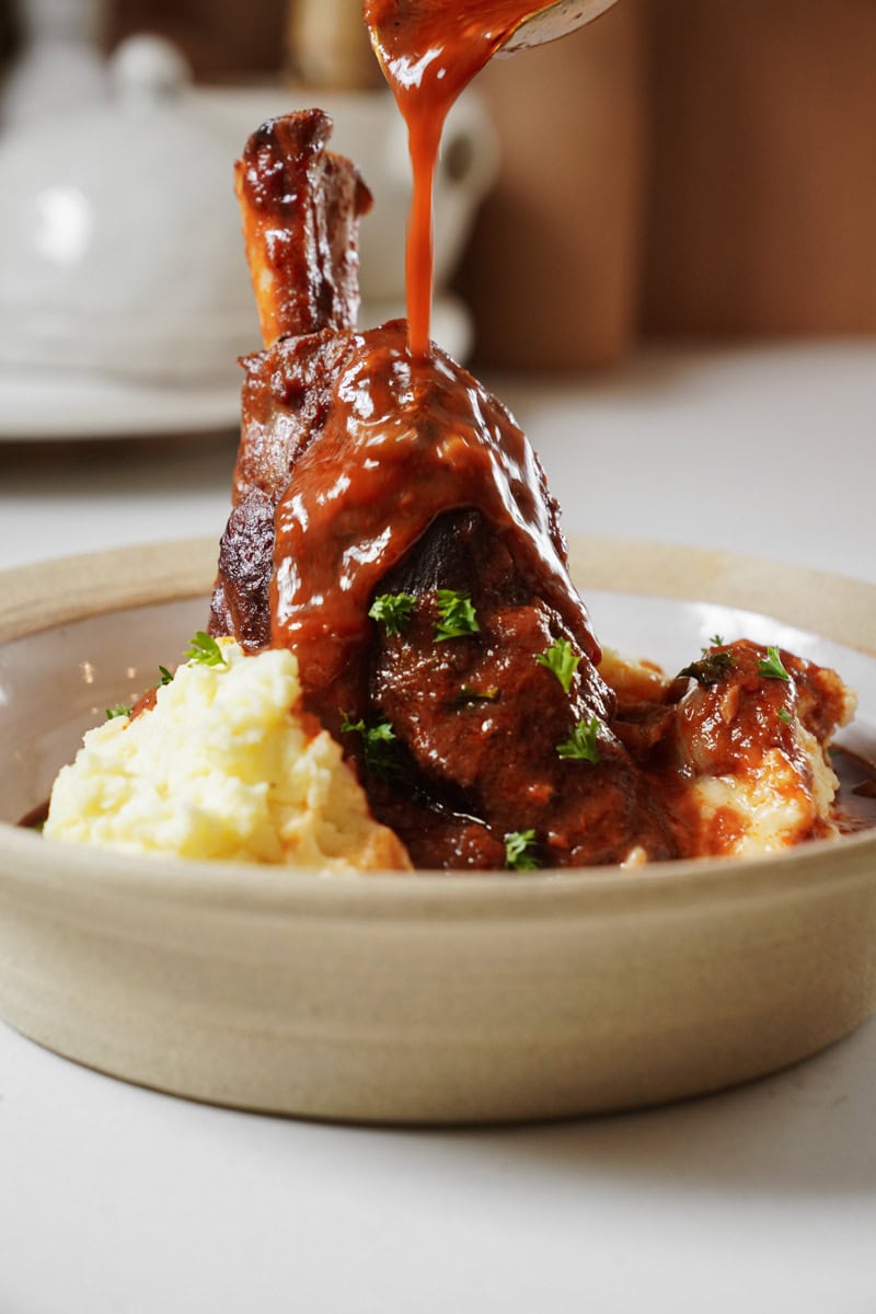 Side view of braised lamb shanks